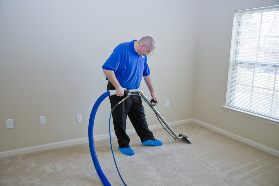 man vacuums the floor